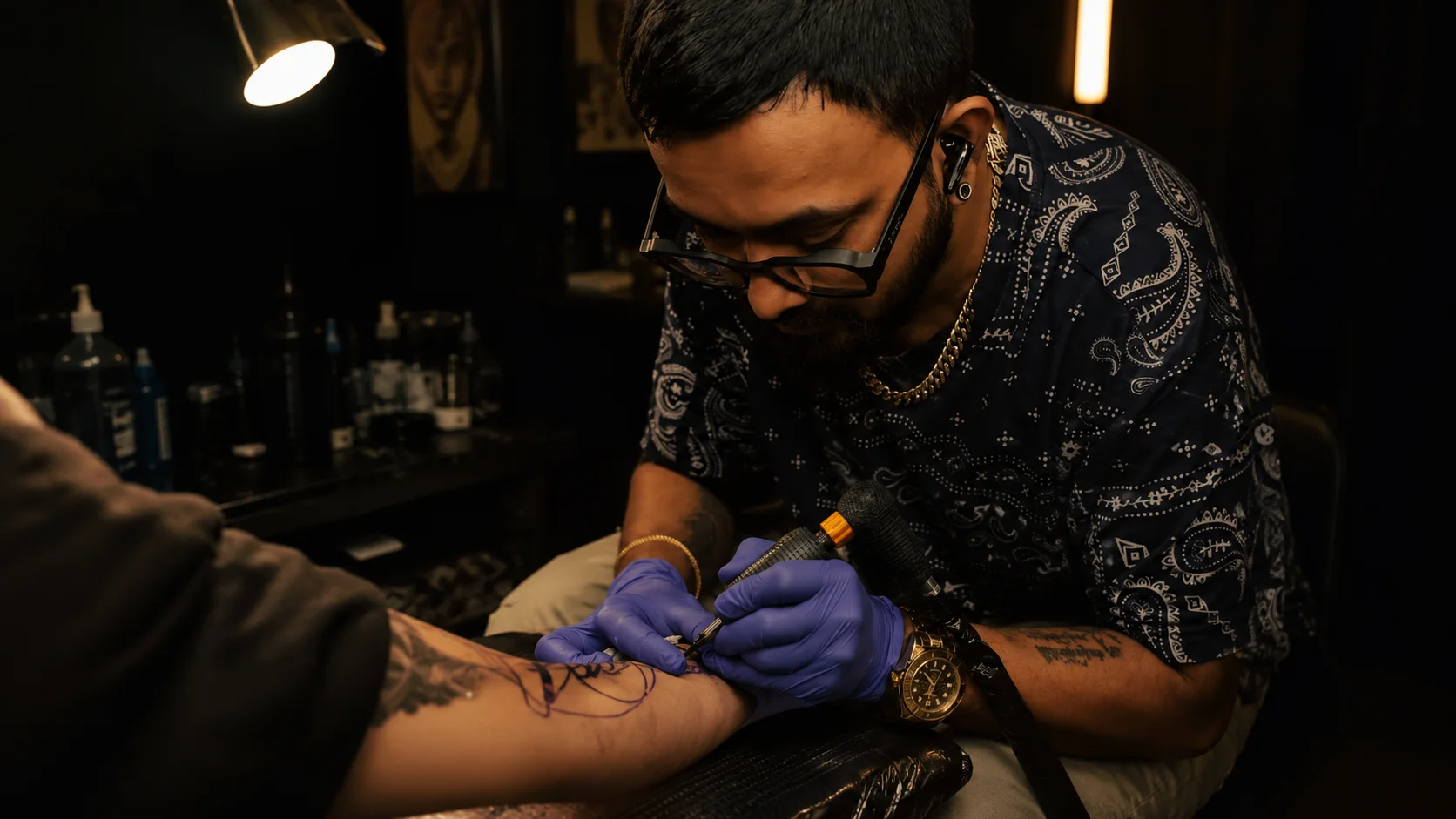 Jigar Parekh tattooing a client in the studio